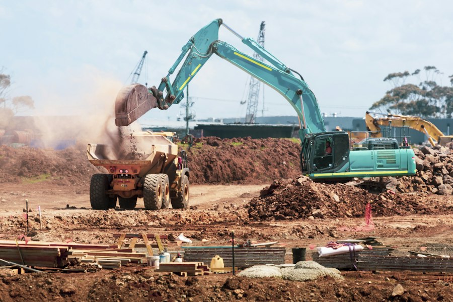 Excavator loading a dump truck on a construction site